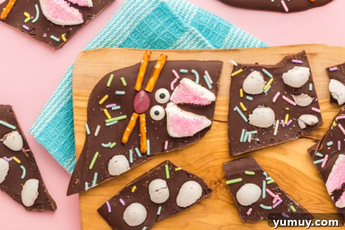 individual pieces of chocolate bunny bark artfully arranged on a rustic wood board