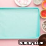 ingredients for easter bunny bark laid out on a table, including chocolate, marshmallows, and sprinkles