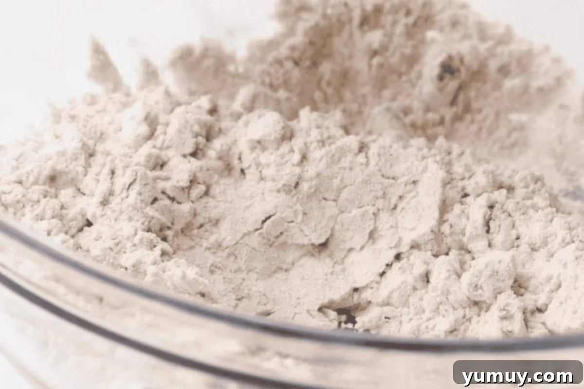 Spiced flour in a glass bowl, ready for mixing into the carrot cake batter.