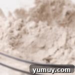 Spiced flour in a glass bowl, ready for mixing into the carrot cake batter.