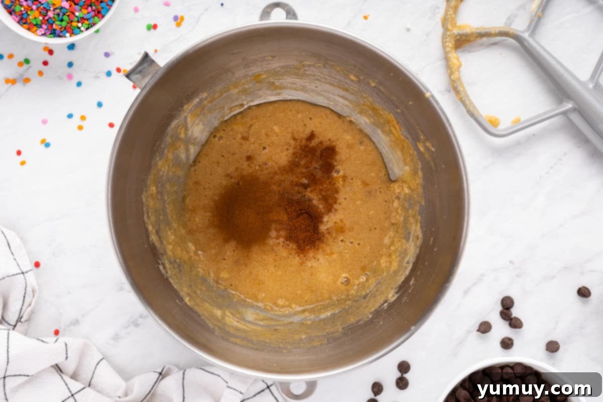 The Legendary Chocolate Chip Cookie Cake 19 wet ingredients for chocolate chip cookie cake in a metal bowl