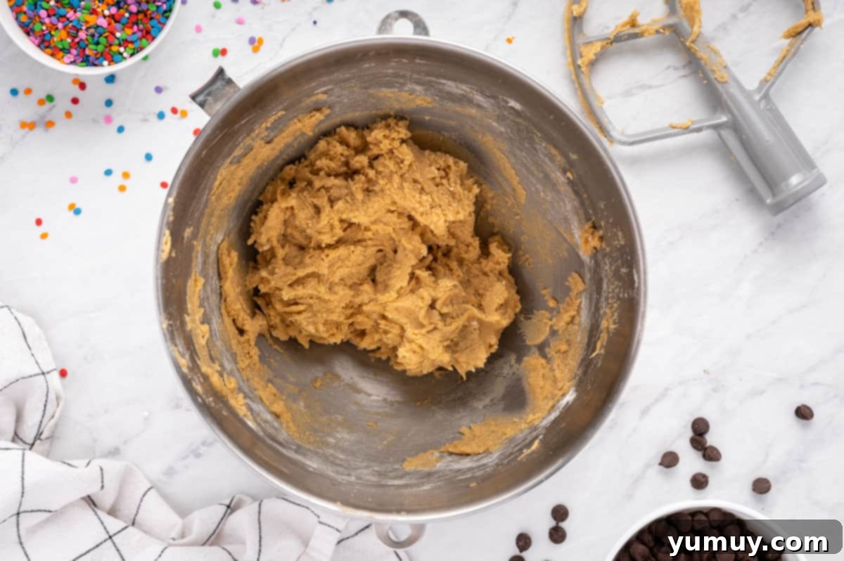 The Legendary Chocolate Chip Cookie Cake 20 cookie cake cookie dough without chocolate chips in a metal bowl