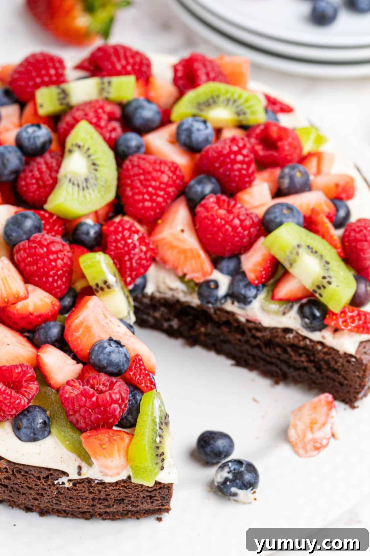 Jeweled Brownie Fruit Tart 2 brownie fruit pizza topped with cream and sliced fruit