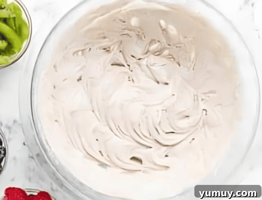 Jeweled Brownie Fruit Tart 13 cream cheese frosting in a glass bowl.