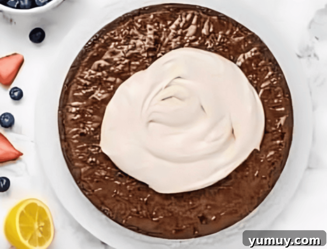 Jeweled Brownie Fruit Tart 15 frosting a brownie.