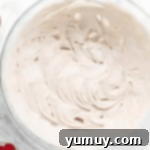 Jeweled Brownie Fruit Tart 7 cream cheese frosting in a glass bowl.