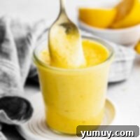 Homemade Lemon Curd: Bright, Tangy Perfection 4 Featured image of a bowl of freshly made lemon curd, garnished with lemon slices.