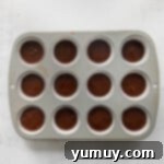 Mint Chocolate Peak Cupcakes 6 Chocolate cupcake batter in a cupcake pan before baking, showing even filling