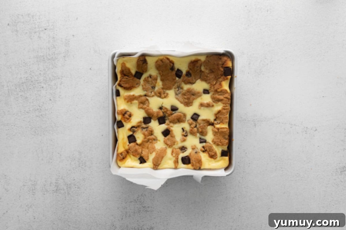 Decadent Chocolate Chip Cheesecake Squares 16 chocolate chip cookie cheesecake bars in a pan after baking