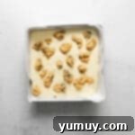 Decadent Chocolate Chip Cheesecake Squares 9 chocolate chip cookie cheesecake bars in a pan before baking