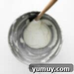 Berry Bliss Macarons 9 macaron batter in a stainless mixing bowl with a rubber spatula.