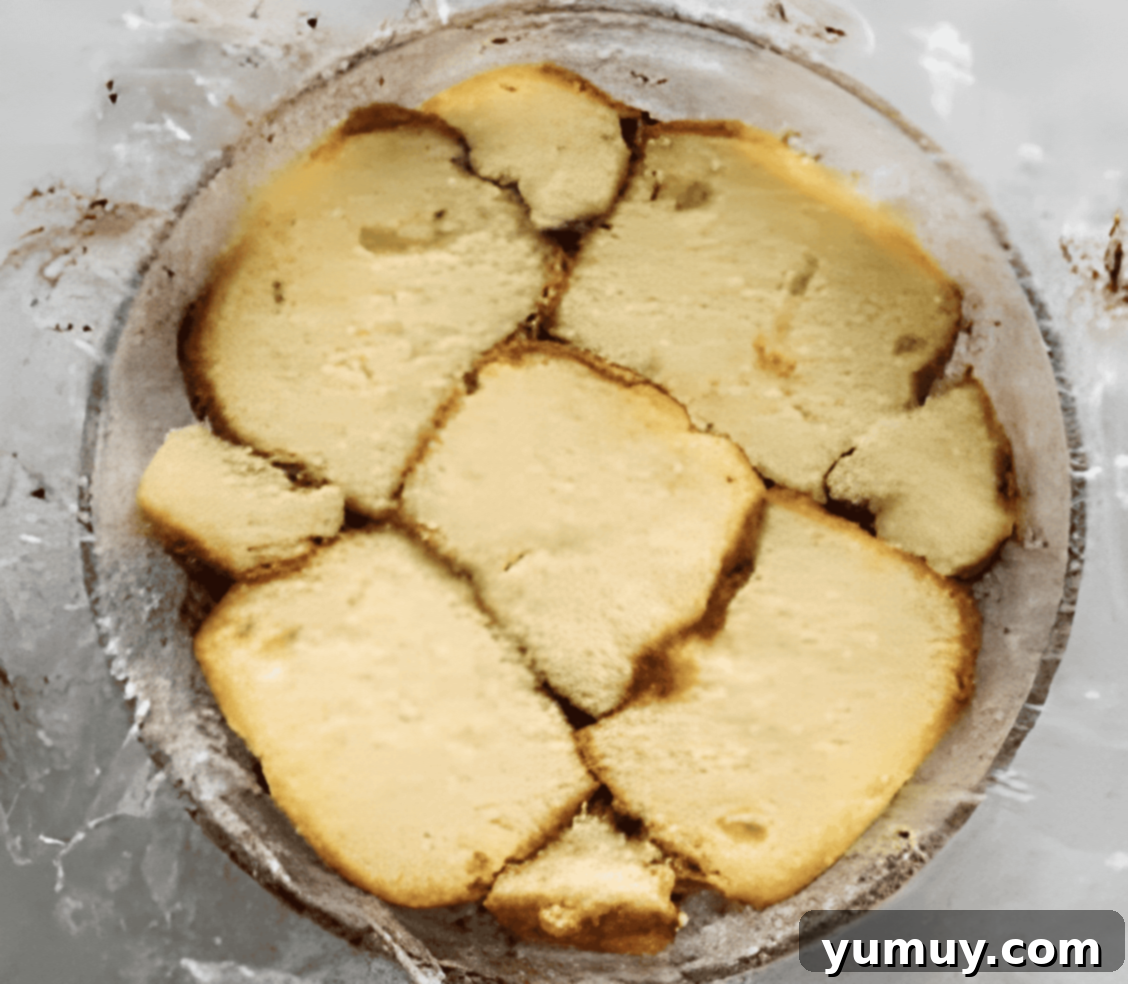 slices of pound cake over ice cream in a glass bowl.
