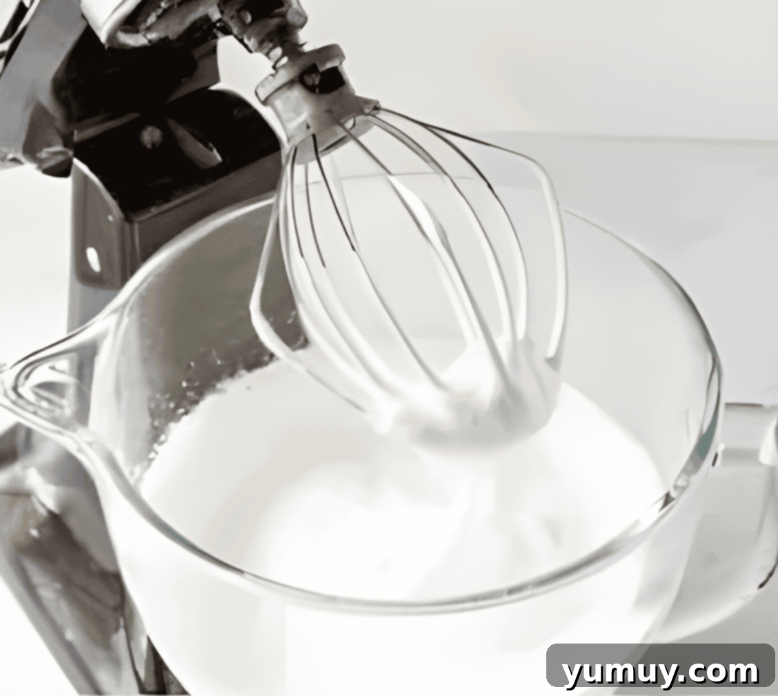 whipped meringue in a stand mixer bowl.