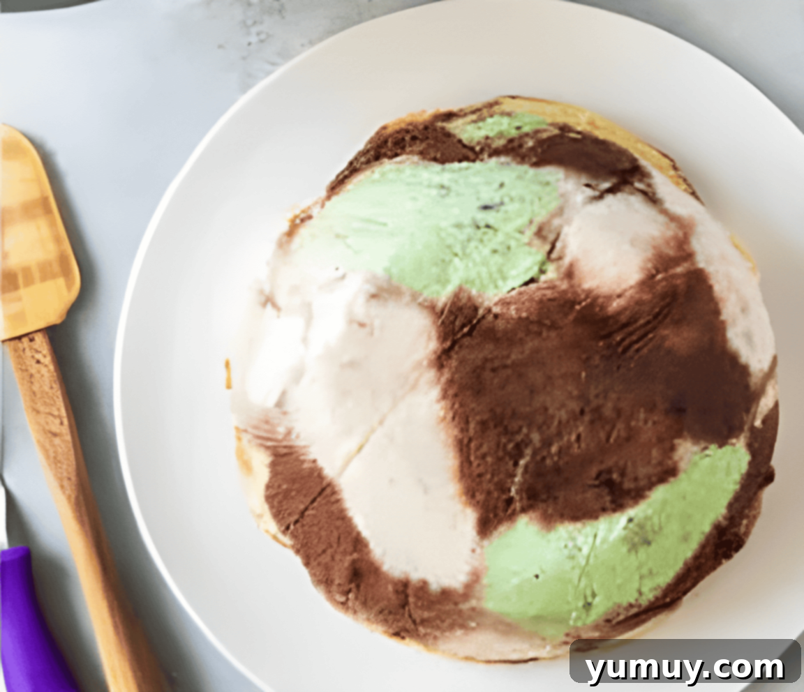 frozen ice cream dome inverted on a white plate.
