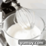 whipped meringue in a stand mixer bowl.