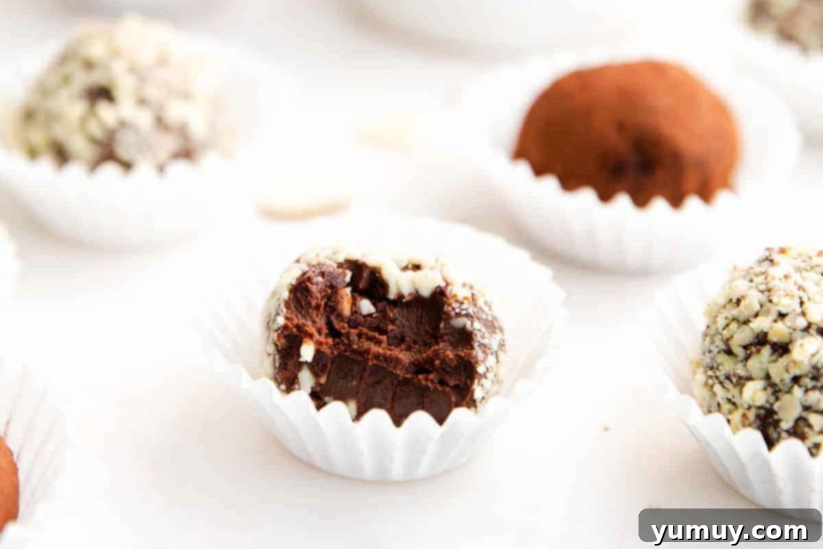 Decadent Amaretto Truffles 3 a bitten amaretto truffle in a mini cupcake liner.