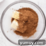 Velvet Chocolate Buttercream 5 sticks of butter and cocoa powder in a glass bowl.