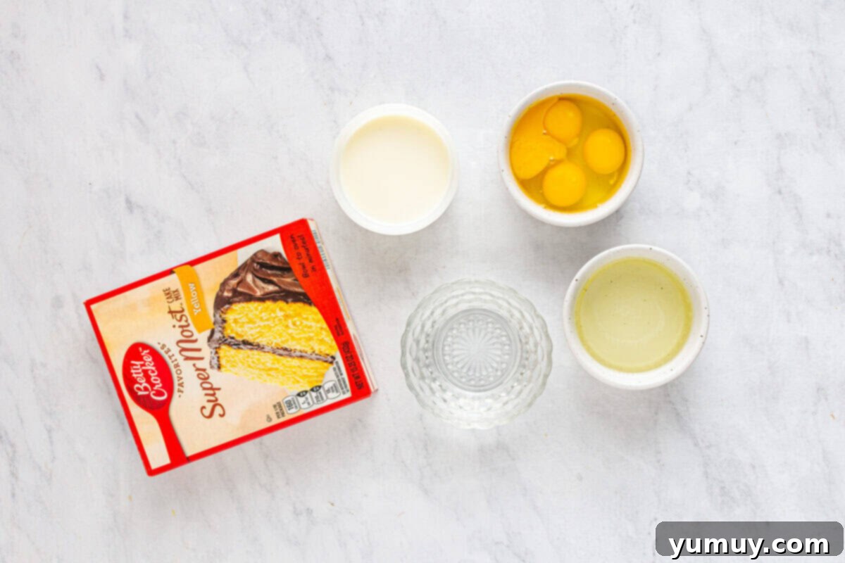 Overhead view of all ingredients for Boston Cream Pie Poke Cake, neatly organized on a kitchen counter.
