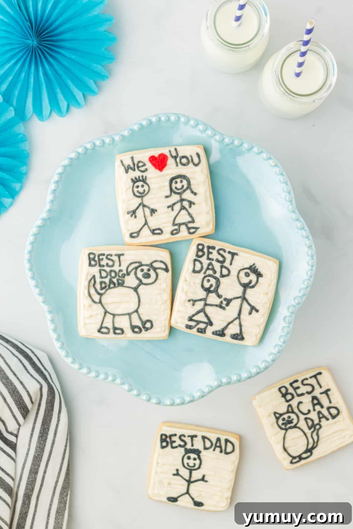 Fathers Day Cookie Creations 3 Three beautifully decorated Father's Day cookies presented on a blue serving dish.