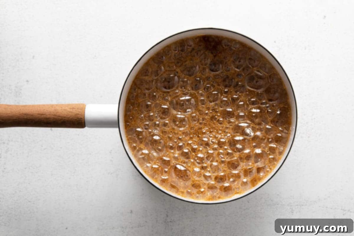 Rich Butterscotch Dream 7 brown sugar mixture boiling in a pot.