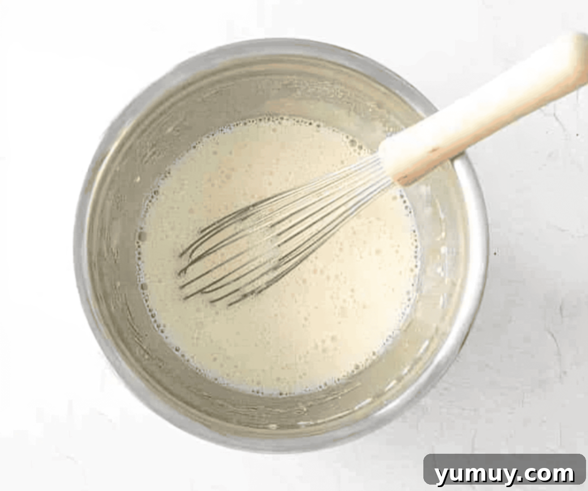 wet ingredients in a stainless mixing bowl with a whisk.