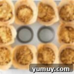 crumb-topped muffin batter in a muffin tin.