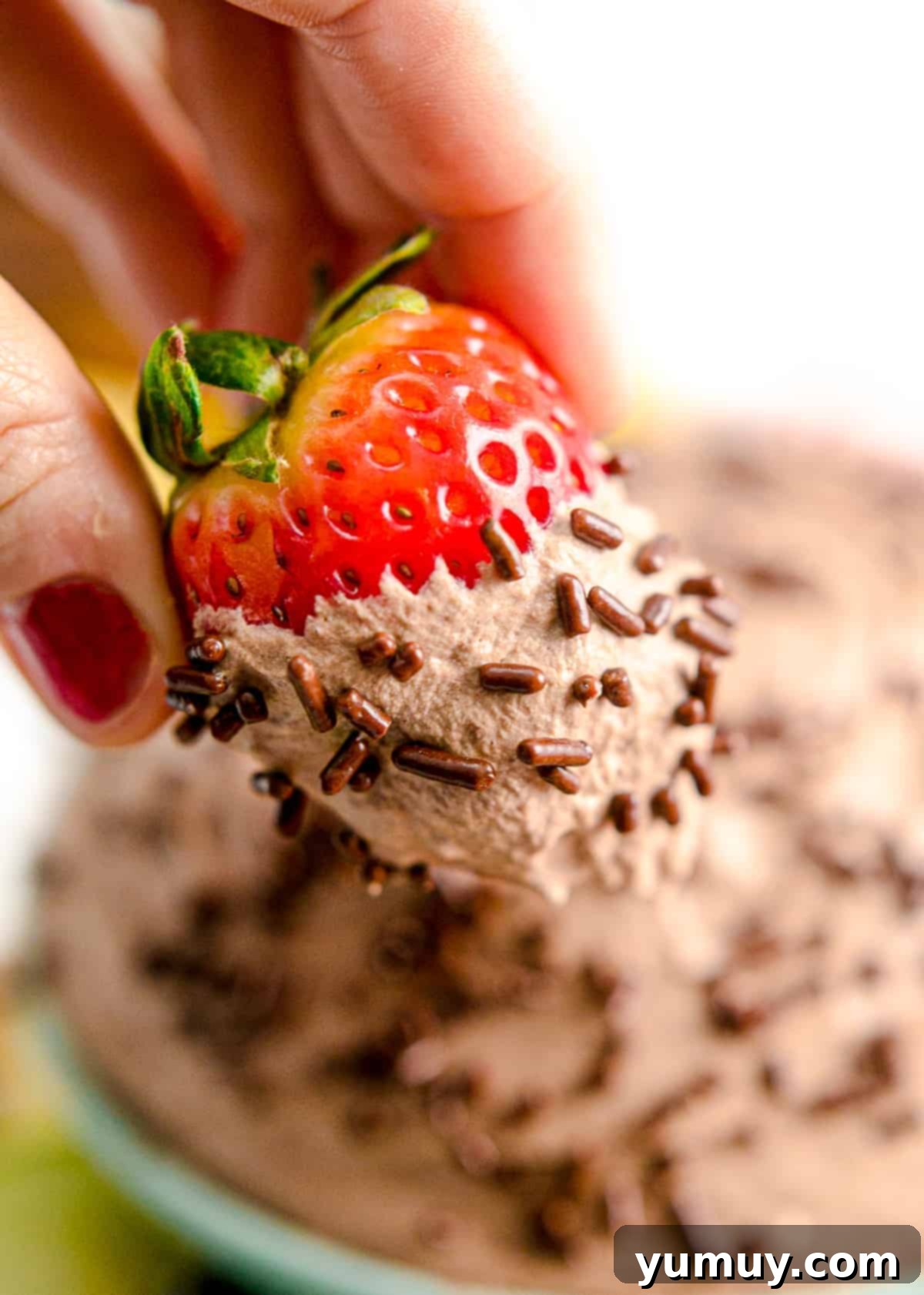 Luscious Chocolate Fruit Delight 3 Close-up of a juicy strawberry generously coated in velvety chocolate fruit dip, ready to be enjoyed.