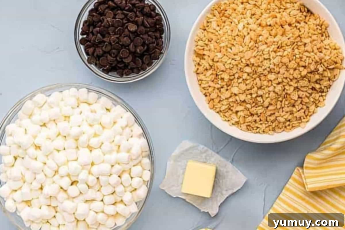 Chocolate Crackle Squares 5 Ingredients for chocolate Rice Krispie treats laid out on a surface.