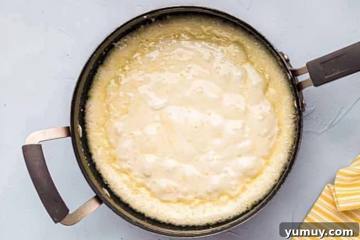 Chocolate Crackle Squares 7 Completely melted marshmallows and butter in a pan, smooth and ready.