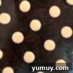 Pup's Peanut Delights 7 Round dog treat cookies lined up on a tray.