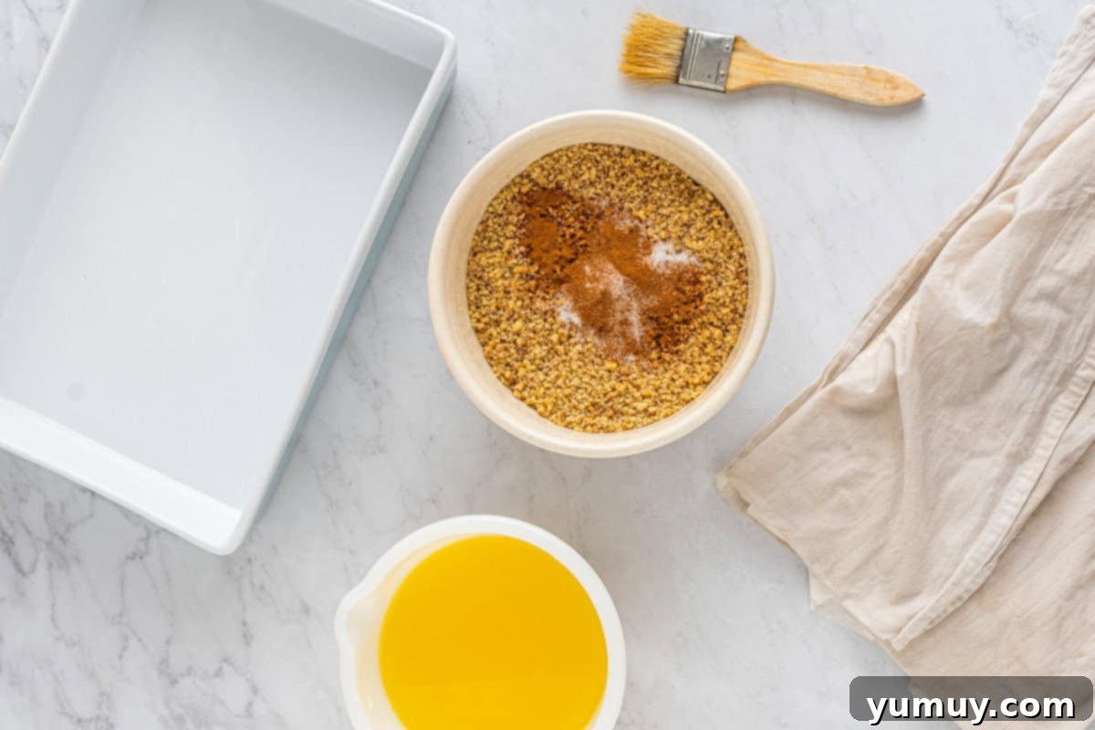 Sweet & Crispy Homemade Greek Baklava 13 A close-up of the walnut, cinnamon, and salt mixture in a white bowl, ready for the baklava filling.
