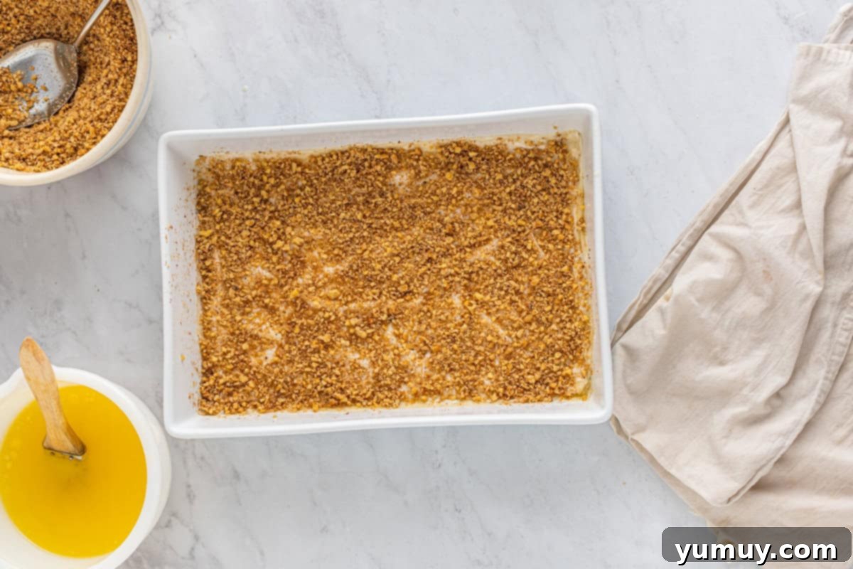 Sweet & Crispy Homemade Greek Baklava 15 The initial layers of baklava filling and phyllo dough visible in the baking pan.