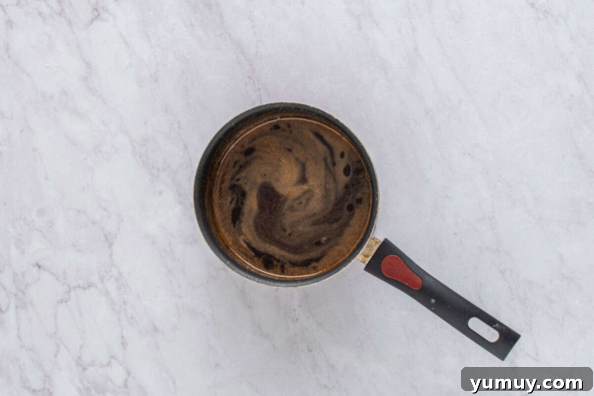 Sweet & Crispy Homemade Greek Baklava 18 The homemade baklava syrup gently simmering in a saucepan, its warm spices infusing.