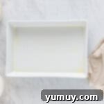 Sweet & Crispy Homemade Greek Baklava 6 A baking pan lightly greased with butter, preparing for the phyllo layers.