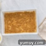 Sweet & Crispy Homemade Greek Baklava 7 Layers of phyllo dough and walnut filling neatly arranged in a baking pan.