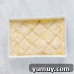 Sweet & Crispy Homemade Greek Baklava 9 Unbaked baklava carefully scored into diamond shapes in the baking pan.