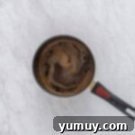 Sweet & Crispy Homemade Greek Baklava 10 Homemade baklava syrup simmering in a saucepan on the stovetop.