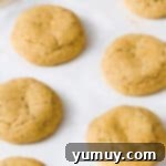 8 baked churro cookies on a baking sheet.