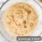 creamed butter and sugars in a glass bowl.