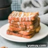 featured churro french toast, garnished with powdered sugar and berries.