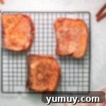 3 slices of churro french toast on a wire rack.