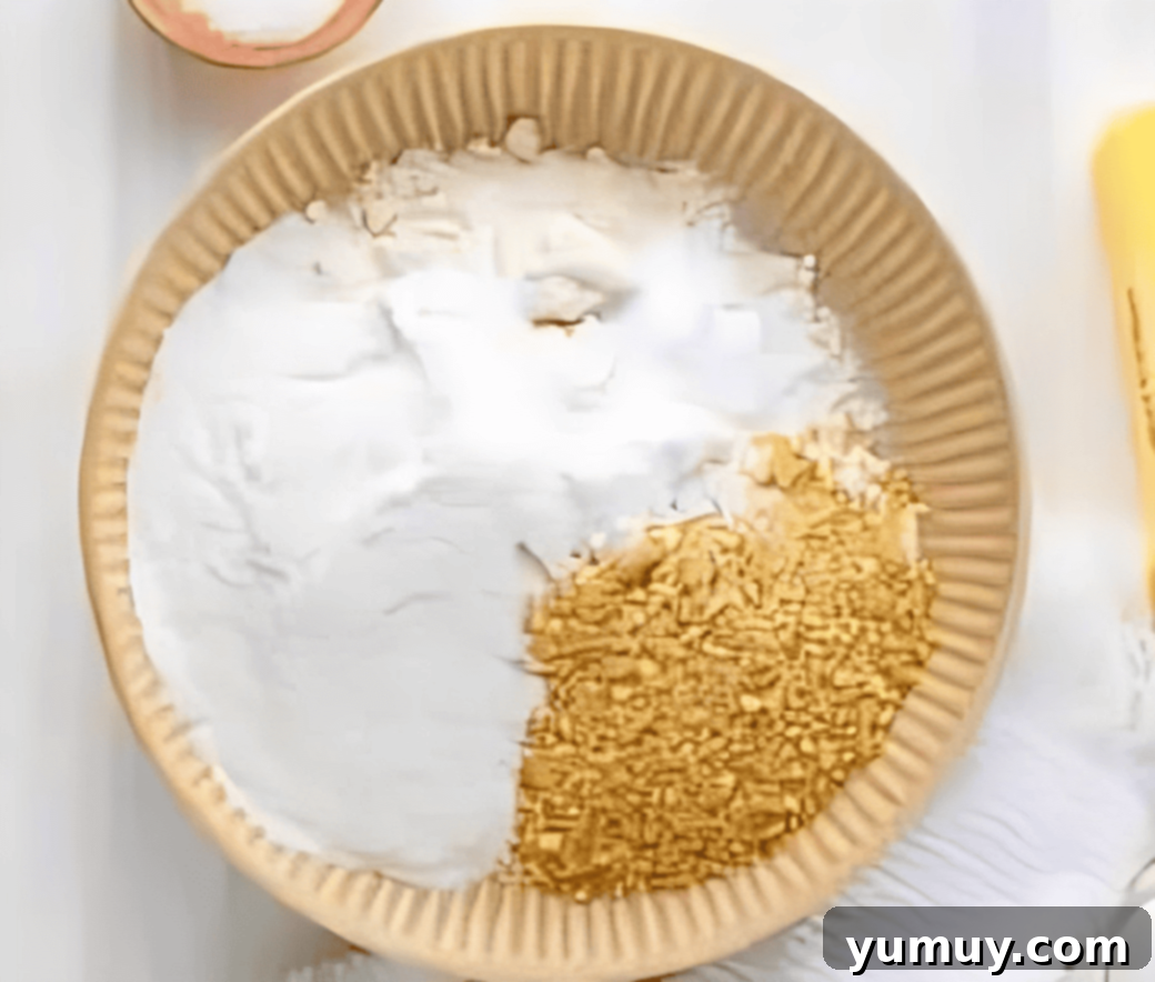 Southern Banana Pudding Cookies 13 A bowl with finely crushed vanilla wafers and flour, being mixed with other dry ingredients including banana pudding mix