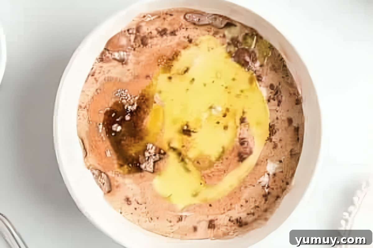 Unmixed chocolate cake batter with wet ingredients in a small white bowl, ready to be combined.