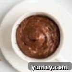 Chocolate cake batter in a white coffee mug.