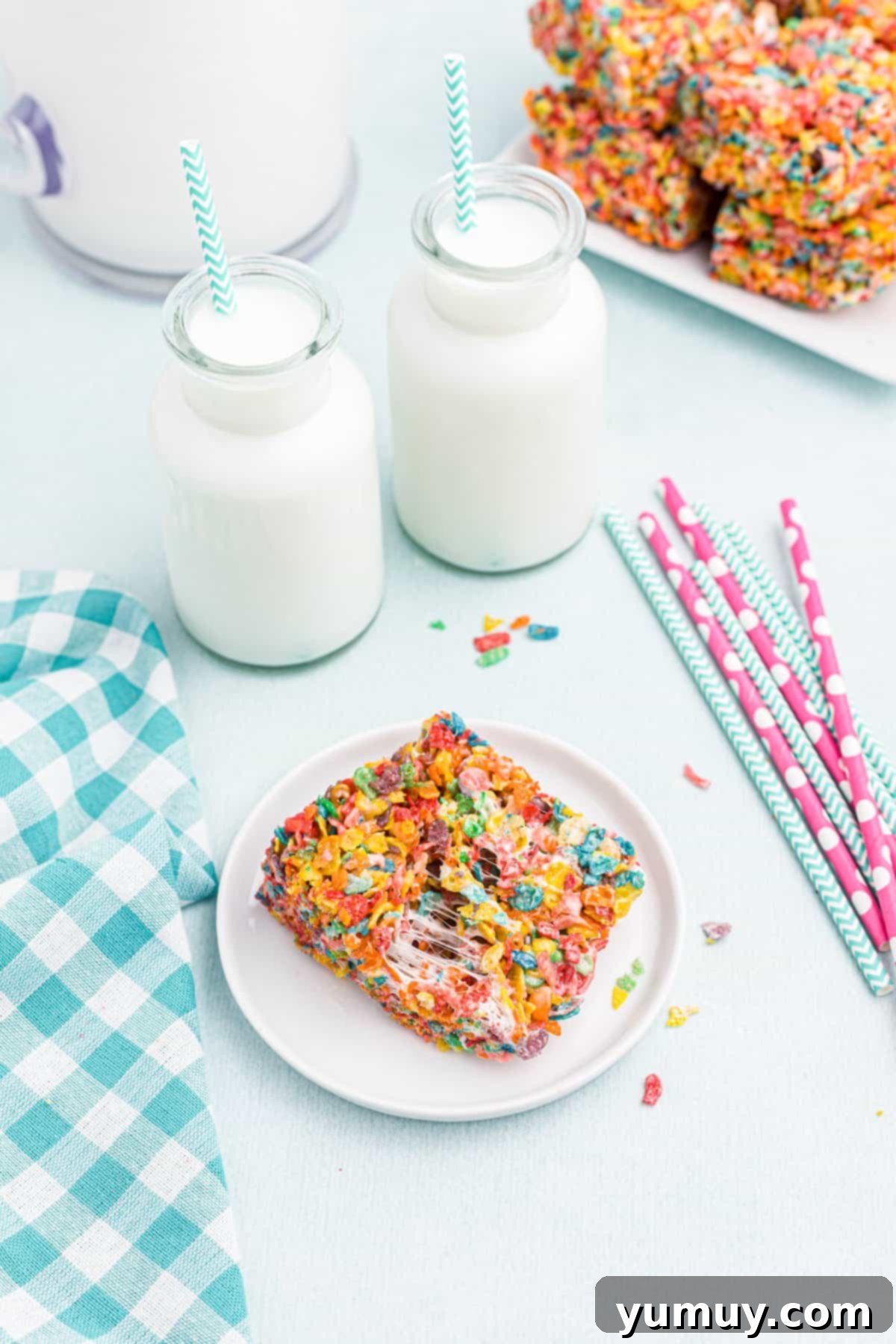 A single, perfectly formed Fruity Pebbles treat on a pristine white plate, showcasing its colorful texture.