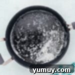 Melted butter shimmering gently in a saucepan, ready for the next step.