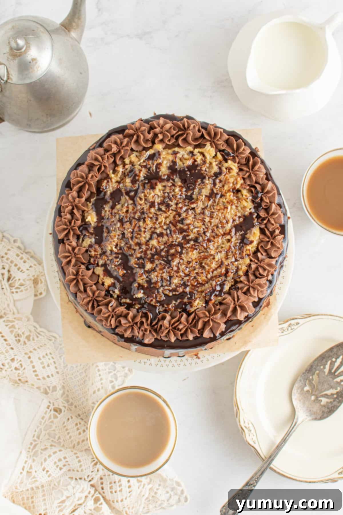 overhead view of german chocolate cake on a white cake stand.