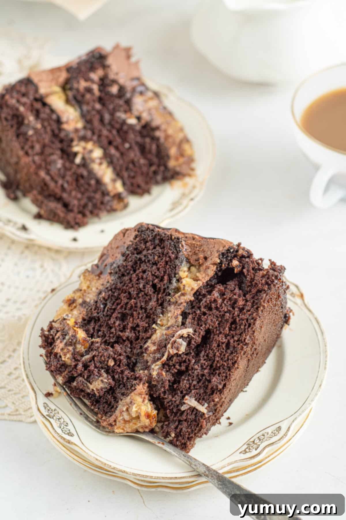 slices of german chocolate cake on white plates with forks.