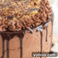 close up of german chocolate cake on a white cake stand.