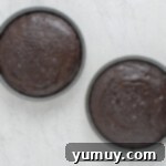 overhead view of baked german chocolate cake layers in round cake pans.